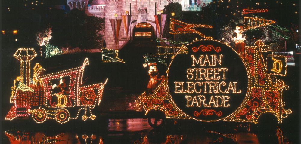 The illuminated locomotive float of the Main Street Electrical Parade at night