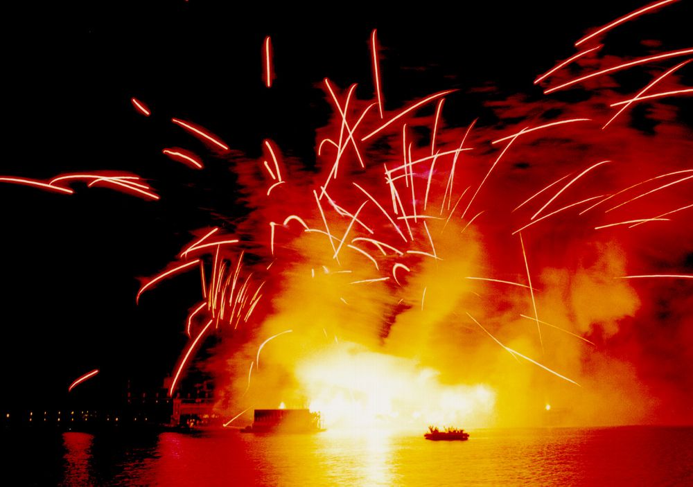 Pyrotechnics and fire on the water during Chaos, the opening scene of Reflections of Earth